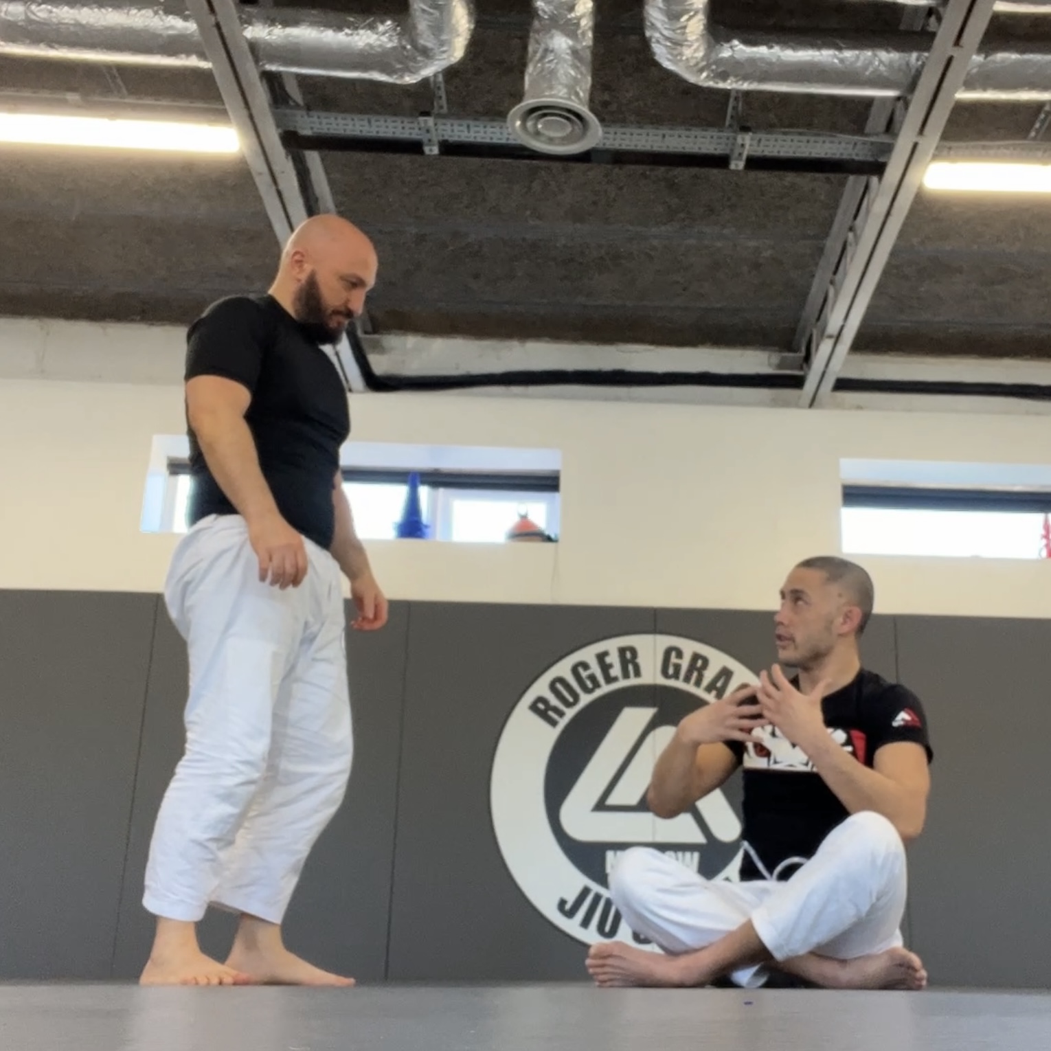 Olgun Tiltay learning grappling from Chris Ong [2nd Dan] BJJ Coach at Roger Gracie Academy